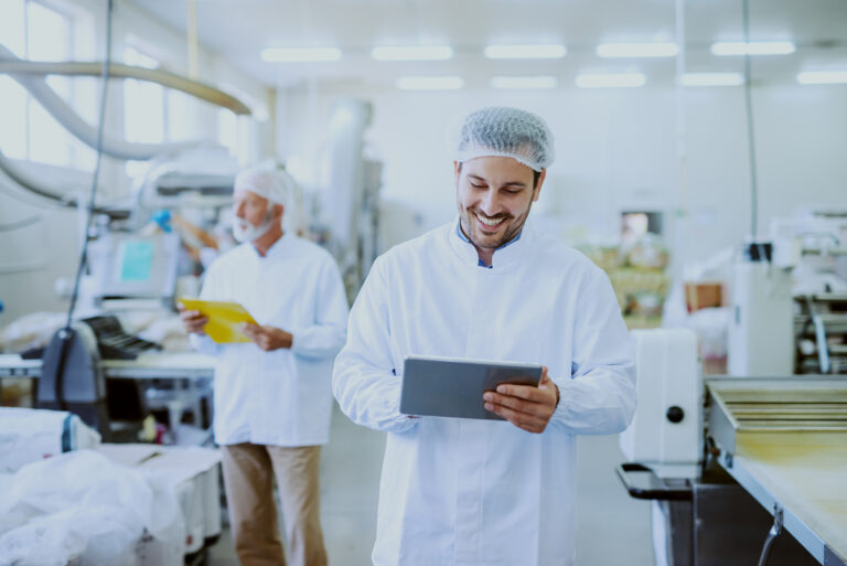 Young,Caucasian,Smiling,Supervisor,In,Sterile,White,Uniform,Using,Tablet